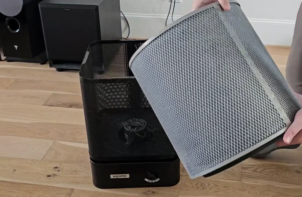 Austin Air HealthMate air purifier beside a litter box area