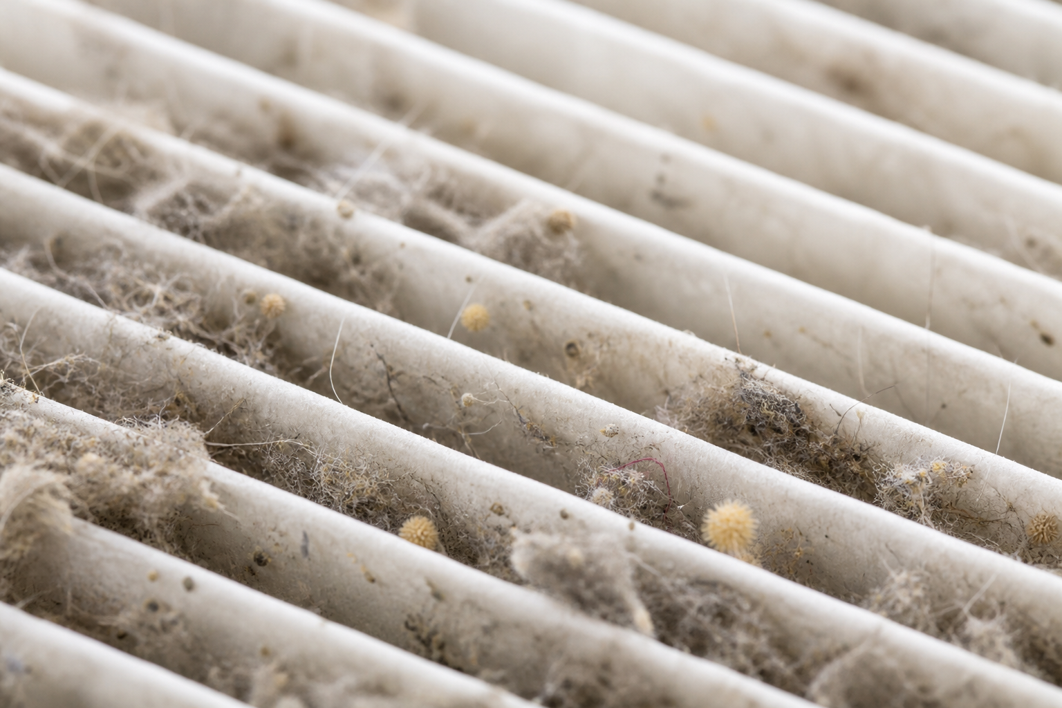Macro detailed view of true HEPA filter pleats capturing fine airborne dust particles